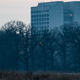 A short-eared owl hunts just after sunset, with Fermilab’s Wilson Hall in the background.